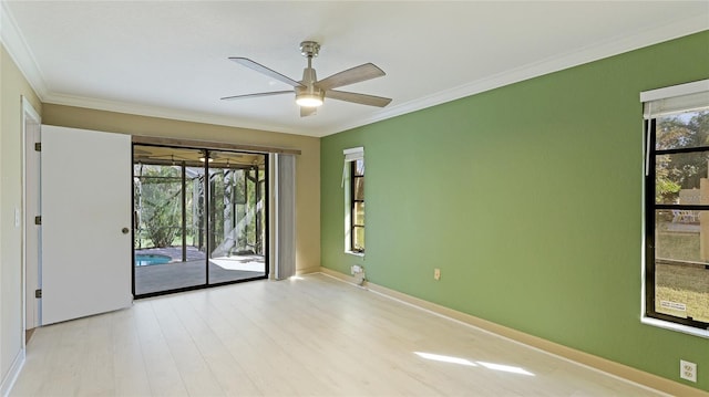 spare room featuring ceiling fan, ornamental molding, a healthy amount of sunlight, and light wood-type flooring