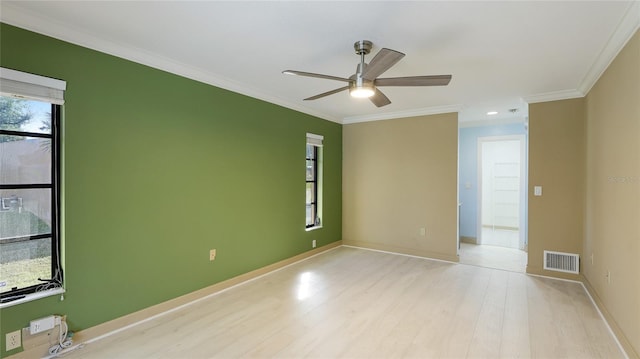 unfurnished room with ceiling fan, light wood-type flooring, and crown molding