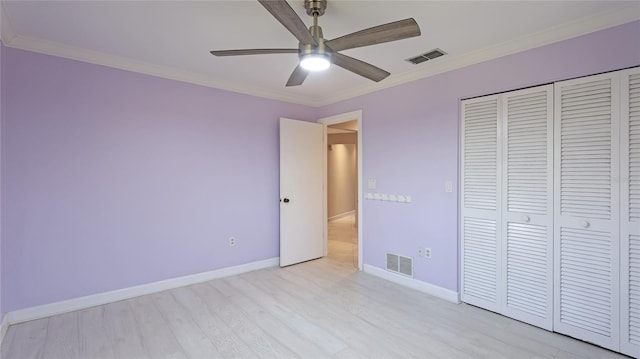 unfurnished bedroom featuring a closet, light hardwood / wood-style flooring, ceiling fan, and crown molding