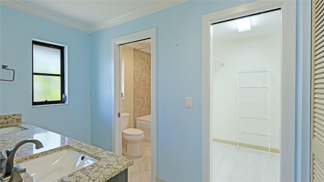 bathroom with tile patterned flooring, vanity, toilet, and ornamental molding