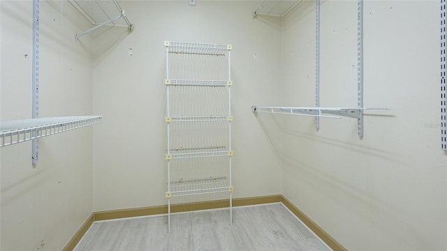 spacious closet featuring light hardwood / wood-style floors