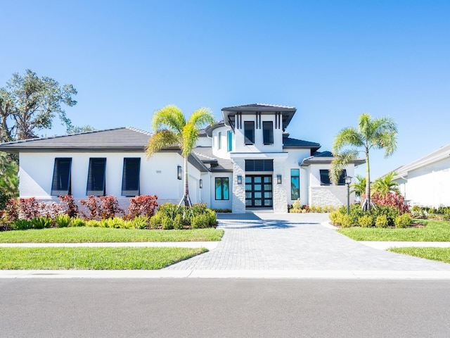 view of front of home featuring a front yard and french doors