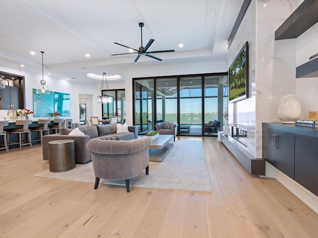 living room featuring ceiling fan and light hardwood / wood-style flooring