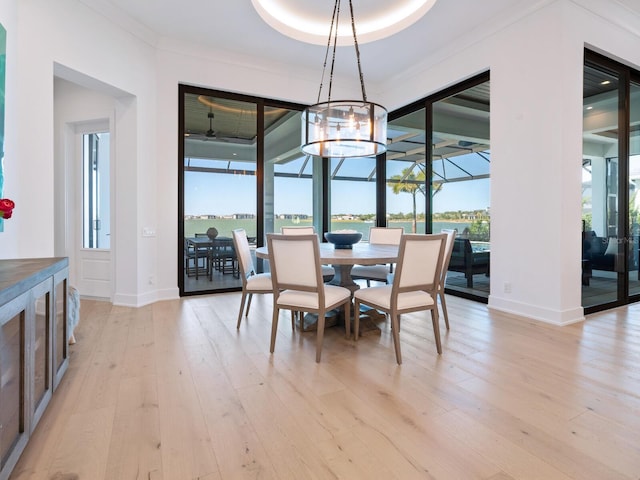 dining room featuring a chandelier, crown molding, and light hardwood / wood-style floors