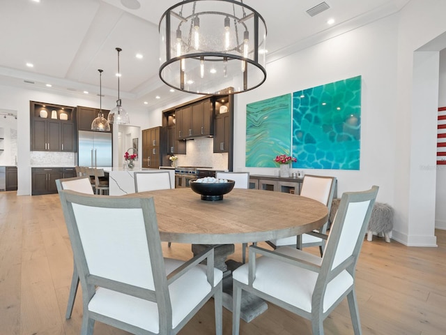 dining area featuring a notable chandelier and light wood-type flooring