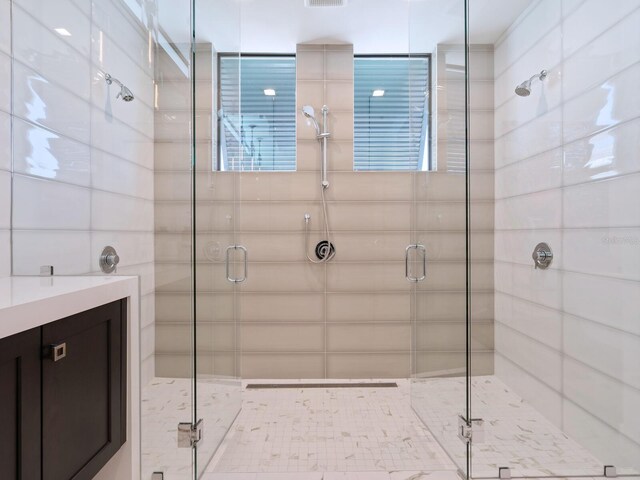 bathroom featuring vanity and a shower with shower door