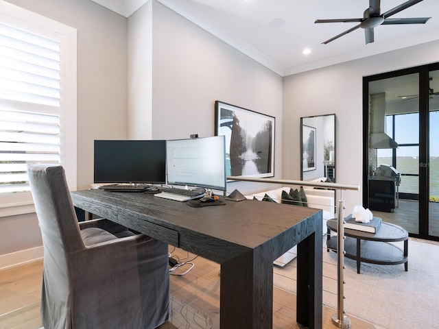 home office with light hardwood / wood-style flooring, ceiling fan, and ornamental molding