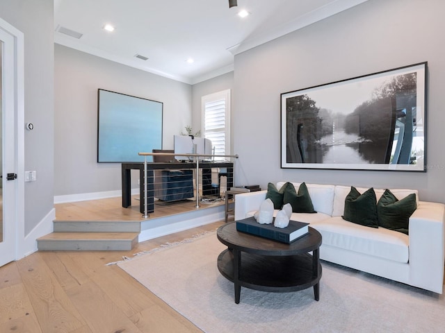 living room featuring light hardwood / wood-style floors and crown molding