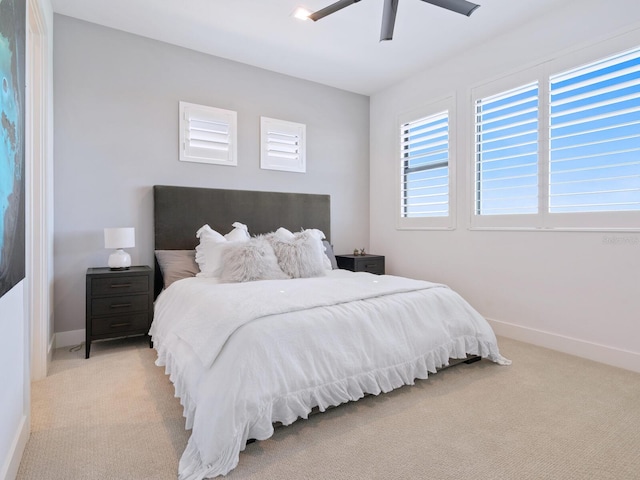 bedroom featuring light carpet and ceiling fan