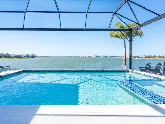 view of swimming pool with a lanai and a water view