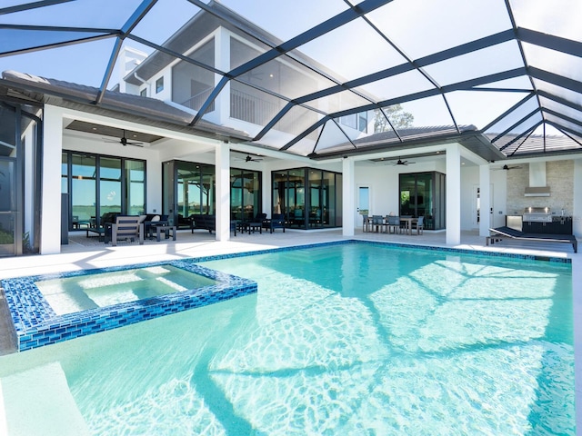 view of pool with ceiling fan, a patio area, a lanai, and an in ground hot tub