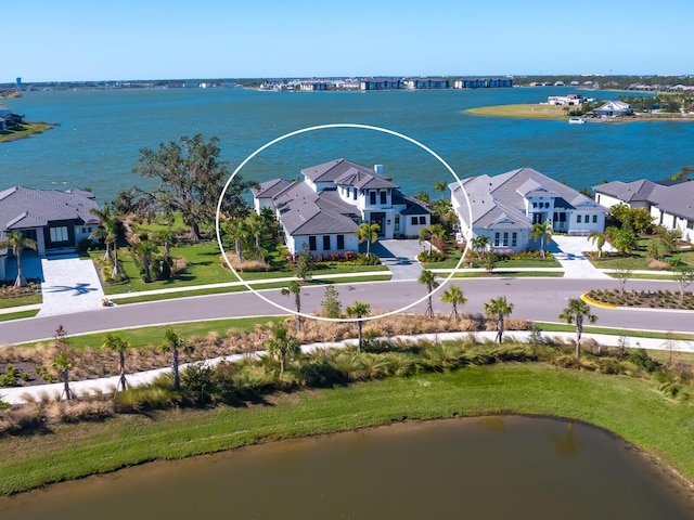 birds eye view of property with a water view