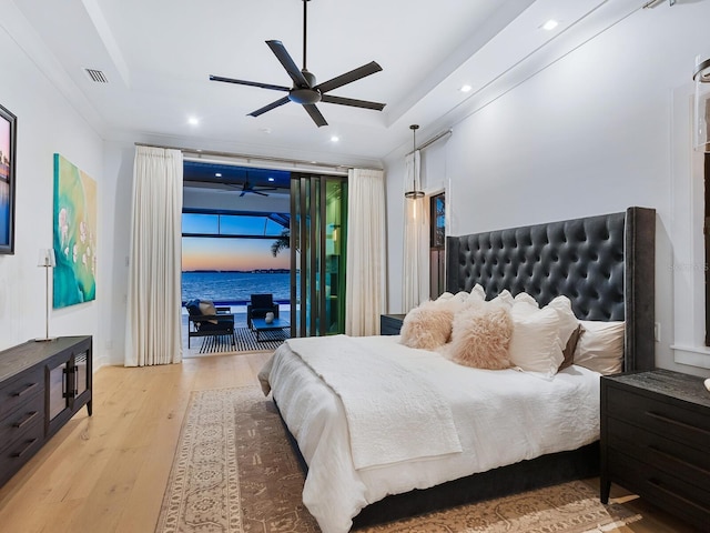 bedroom with a raised ceiling, crown molding, ceiling fan, access to exterior, and light wood-type flooring