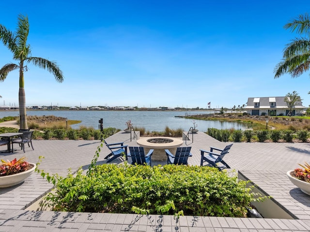 exterior space with a fire pit and a water view