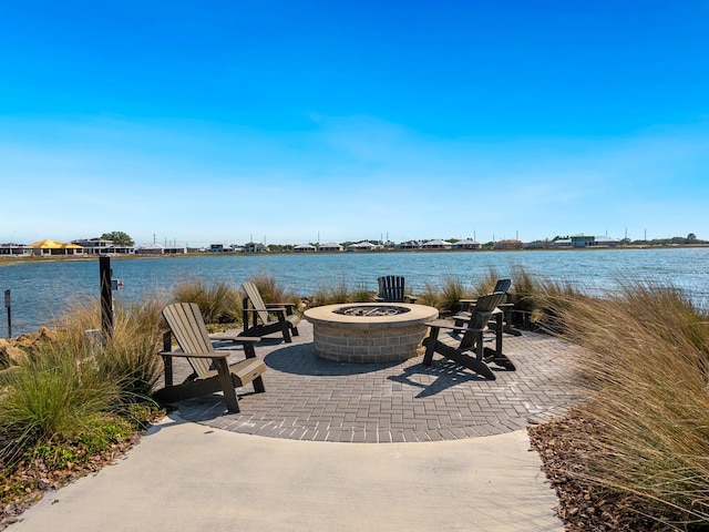 view of patio featuring a fire pit and a water view