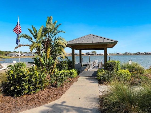 view of dock featuring a gazebo and a water view