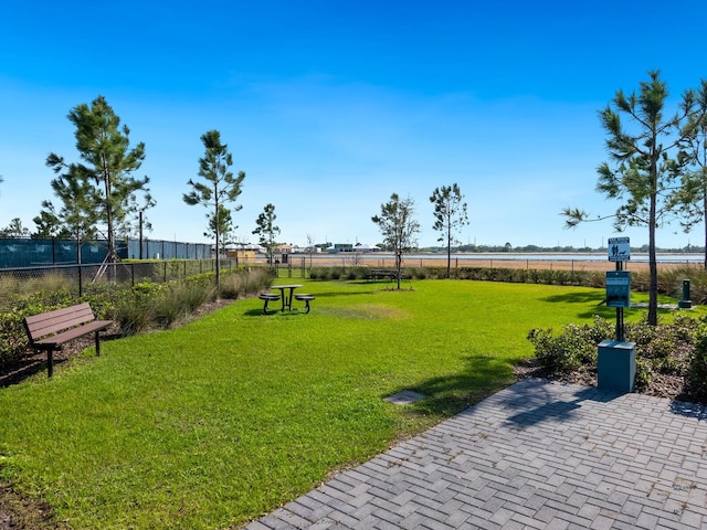 surrounding community featuring a yard and a water view