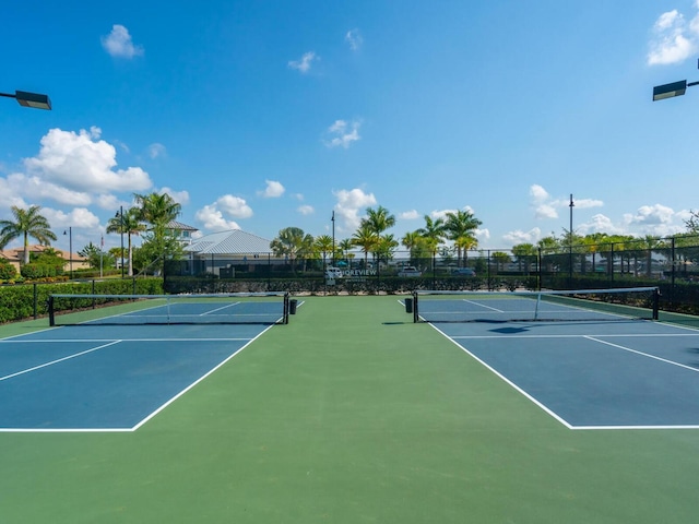 view of tennis court featuring basketball hoop