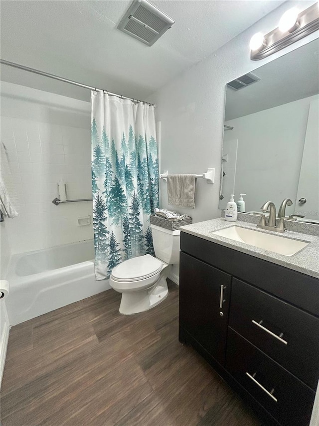 full bath with toilet, shower / tub combo, wood finished floors, vanity, and visible vents