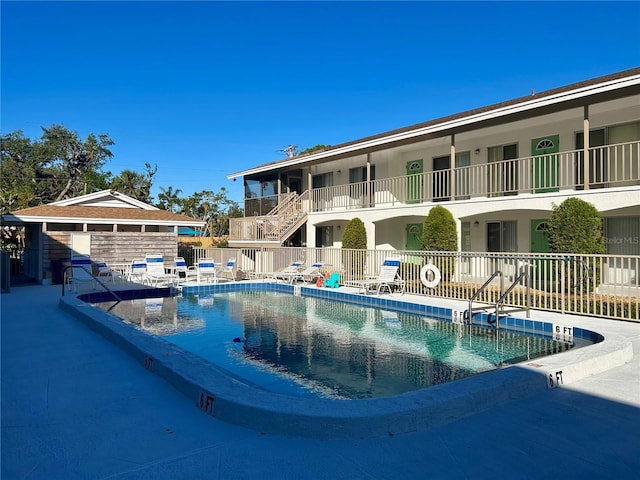 community pool featuring a patio area and fence