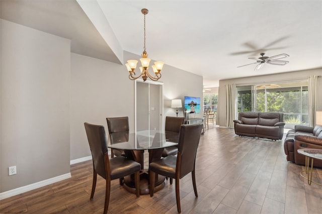 dining room featuring hardwood / wood-style floors and ceiling fan with notable chandelier