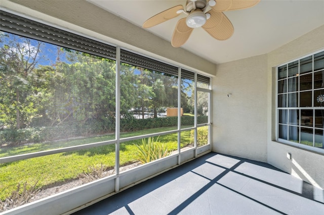 unfurnished sunroom with ceiling fan