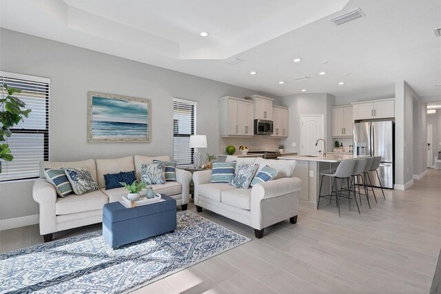 364 Palmaria Ct, Nokomis, FL 34275 - living room featuring plenty of natural light, recessed lighting, and a tray ceiling