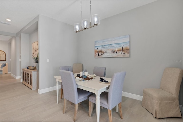 dining room with a notable chandelier