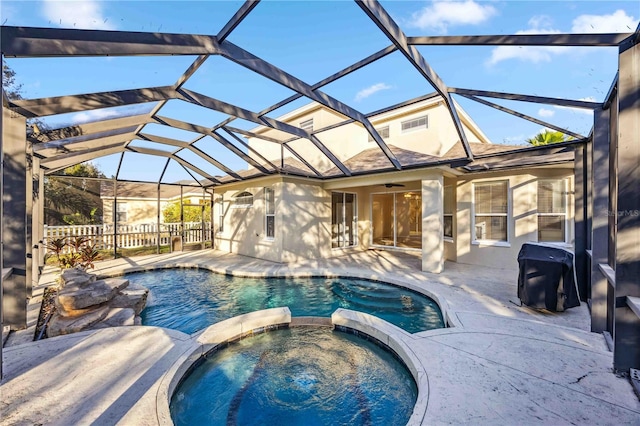 view of swimming pool with an in ground hot tub, area for grilling, a lanai, ceiling fan, and a patio area