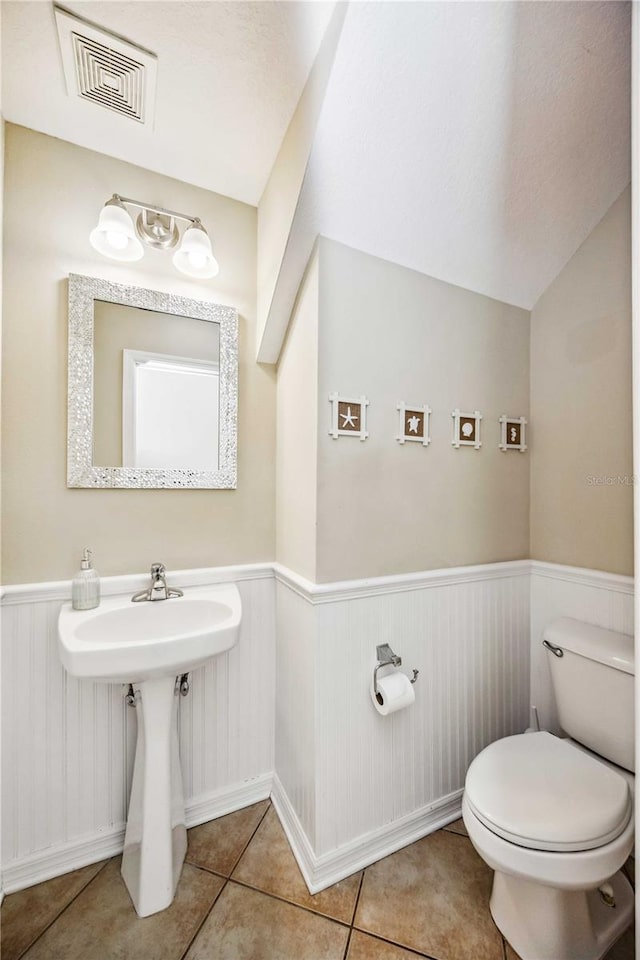 bathroom with tile patterned flooring and toilet