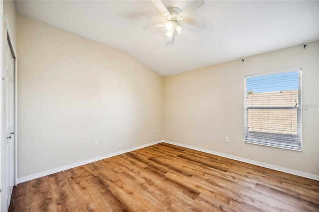 unfurnished room with lofted ceiling, ceiling fan, and wood-type flooring