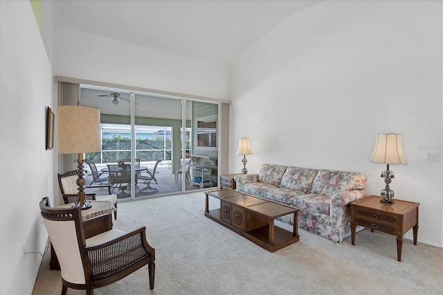 carpeted living room featuring ceiling fan and lofted ceiling