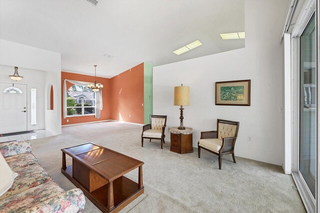 living room featuring light colored carpet and an inviting chandelier