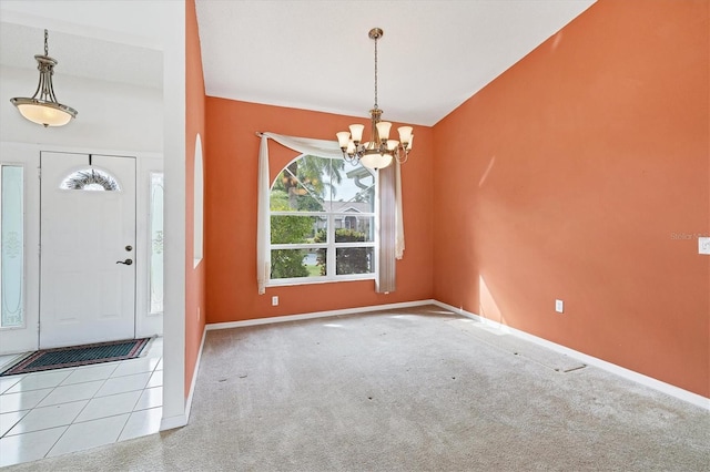 foyer with light carpet and an inviting chandelier