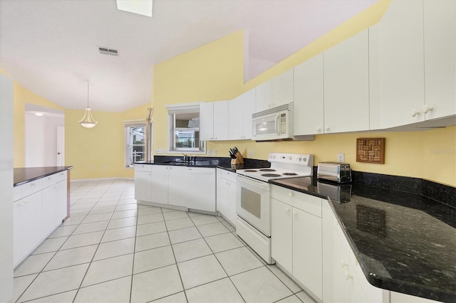 kitchen with white cabinets, dark stone countertops, pendant lighting, white appliances, and light tile patterned floors