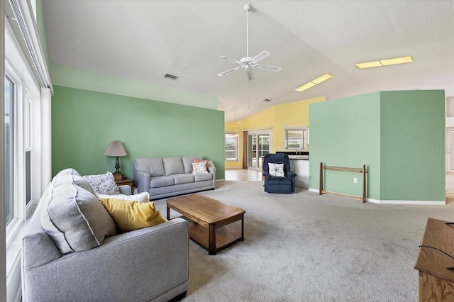 living room featuring ceiling fan, light colored carpet, and lofted ceiling