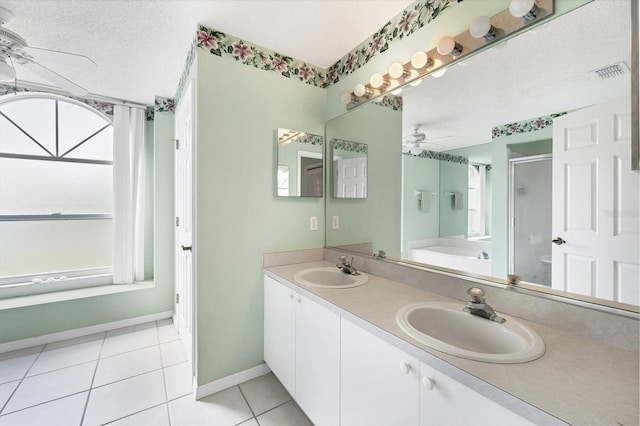 bathroom with tile patterned floors, vanity, a textured ceiling, ceiling fan, and shower with separate bathtub