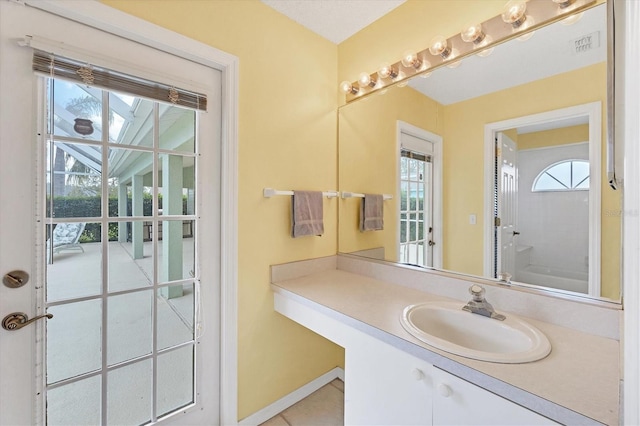 bathroom featuring a wealth of natural light and vanity