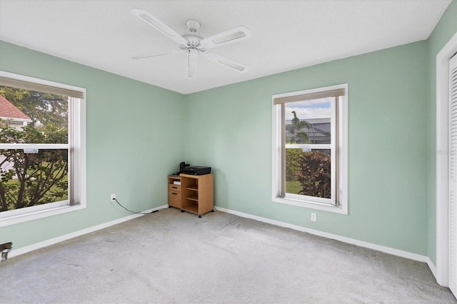 spare room with light carpet and ceiling fan