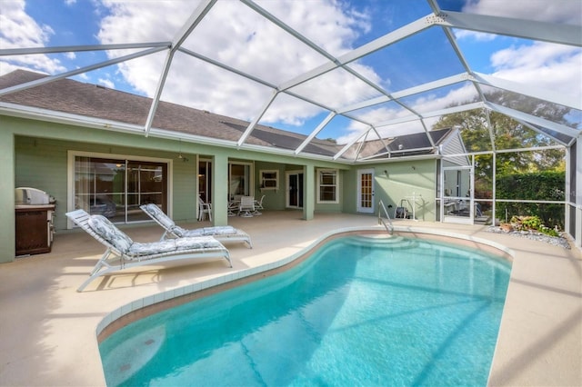 view of swimming pool featuring a lanai and a patio area