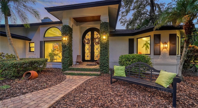 view of exterior entry at dusk