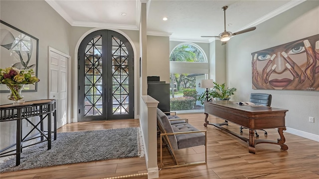 entrance foyer with french doors, hardwood / wood-style flooring, ceiling fan, and crown molding