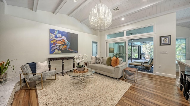 living room with lofted ceiling with beams and a chandelier