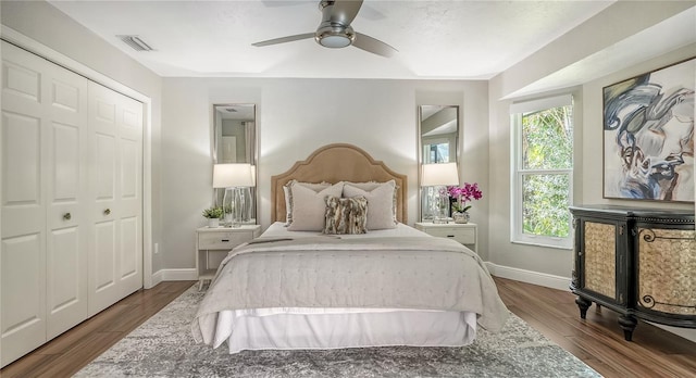 bedroom featuring ceiling fan, a closet, and dark wood-type flooring