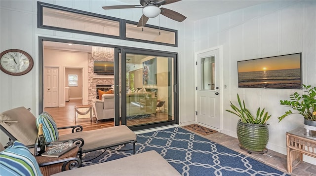 interior space with ceiling fan and a fireplace