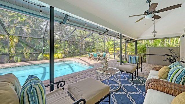 view of pool featuring outdoor lounge area, glass enclosure, ceiling fan, and a patio area