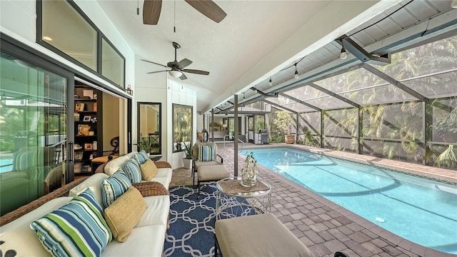 view of swimming pool with outdoor lounge area, ceiling fan, a patio, and glass enclosure