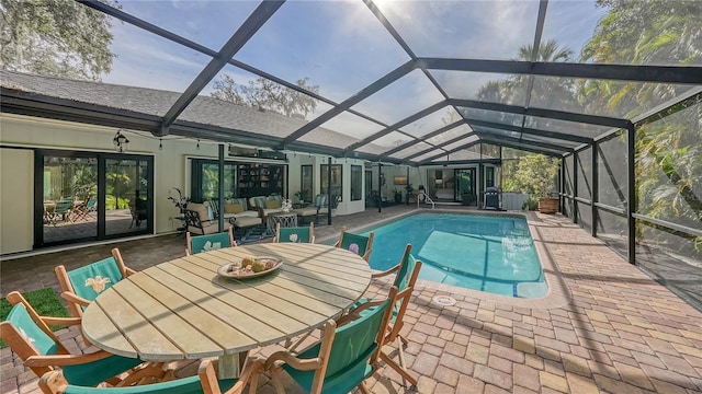 view of pool featuring glass enclosure and a patio