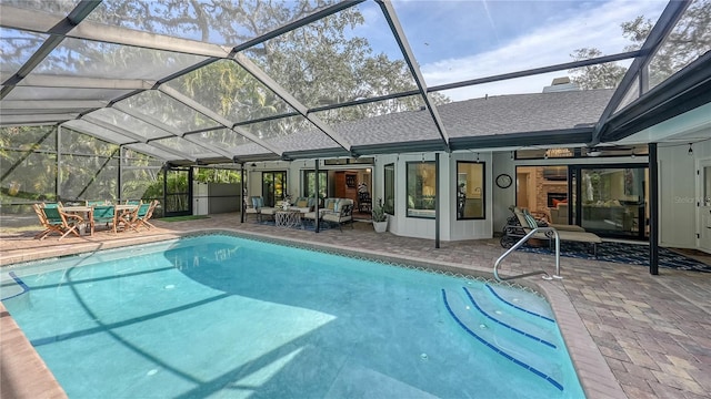 view of swimming pool with outdoor lounge area, glass enclosure, and a patio area