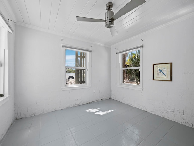 611 Hibiscus Way, Longboat Key, FL 34228 - empty room with crown molding, a ceiling fan, tile patterned floors, and a healthy amount of sunlight